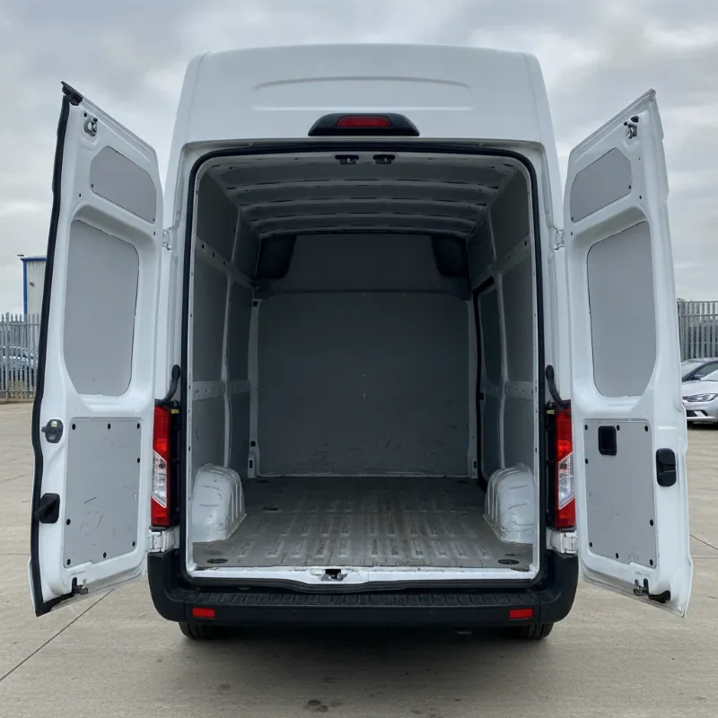 The open rear load area of a large Ford Transit panel van, showing its depth and width