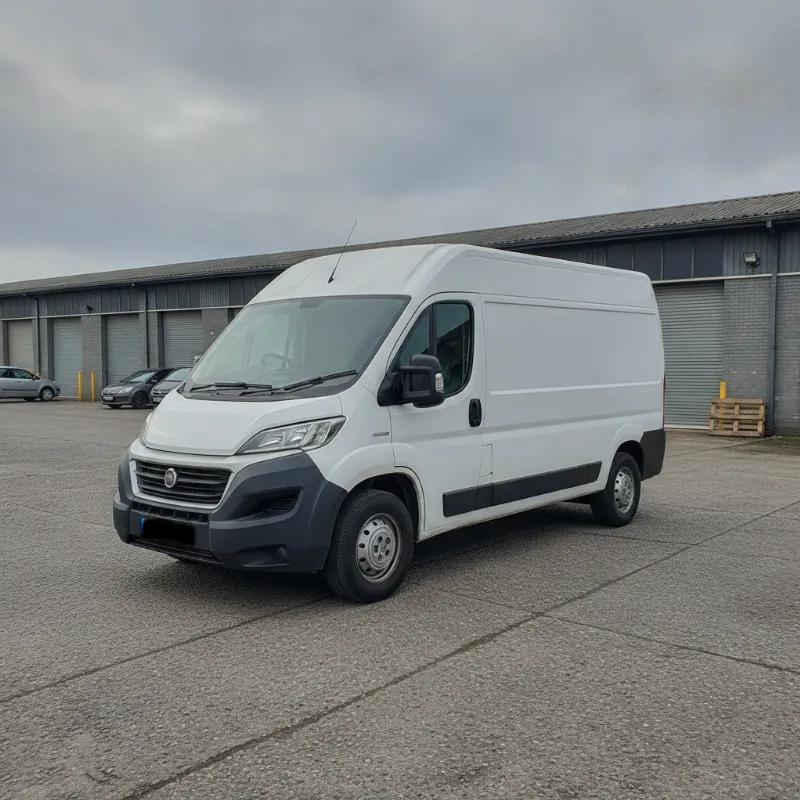 A Fiat Ducato large panel van parked on a UK industrial estate forecourt