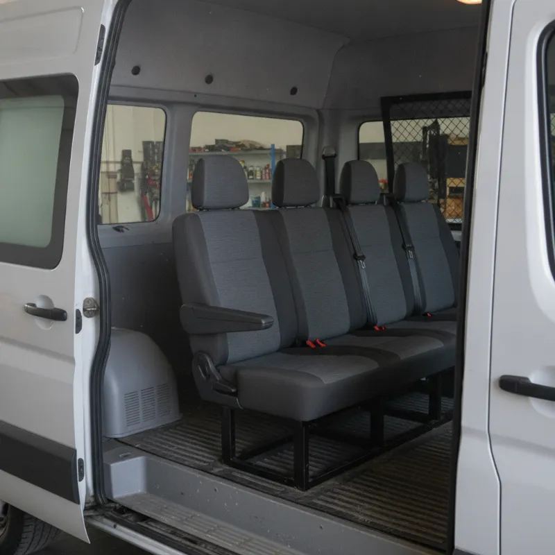 The crew-cab interior of a van, showing two rows of seats