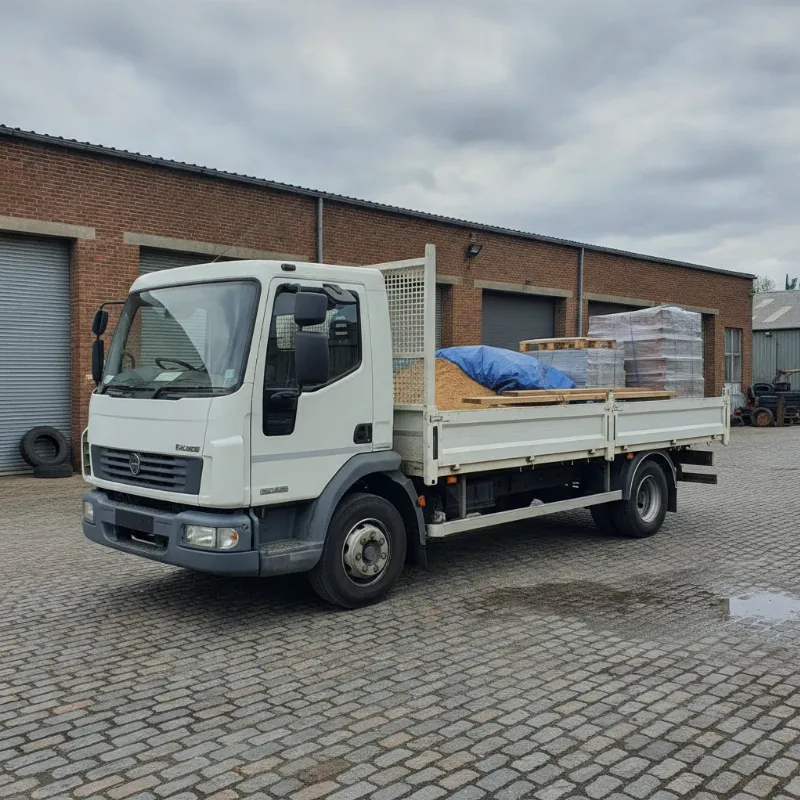 A dropside truck with one side panel folded down, showing the flatbed load area