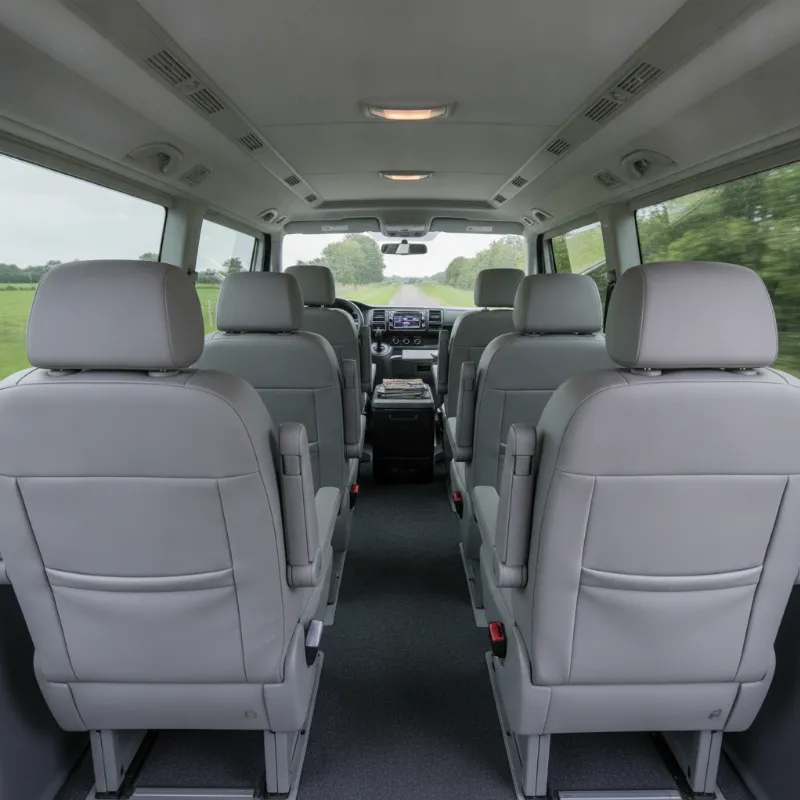 The spacious passenger interior of a Volkswagen Caravelle people carrier, showing rows of individual seats