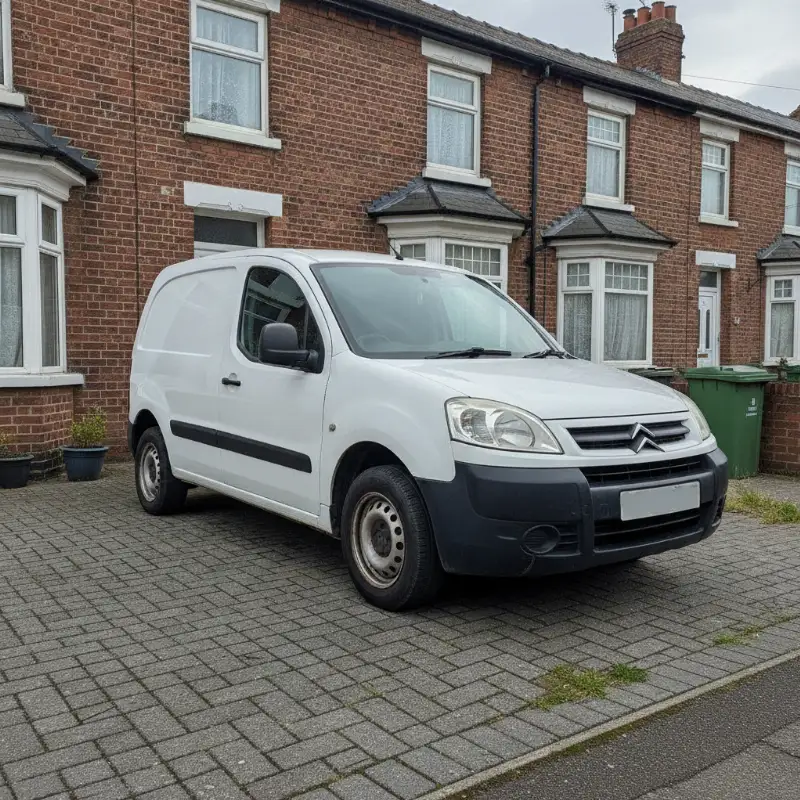 A Citroen Berlingo small van parked on a driveway in front of a UK terraced house