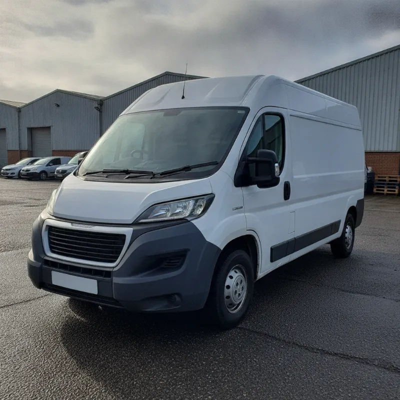 A Peugeot Boxer large panel van parked on a UK industrial estate forecourt