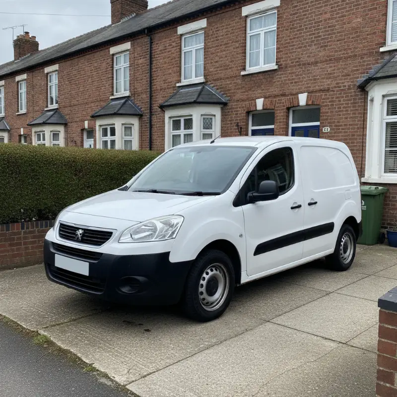 A Peugeot Partner small van parked on a driveway in front of a UK terraced house